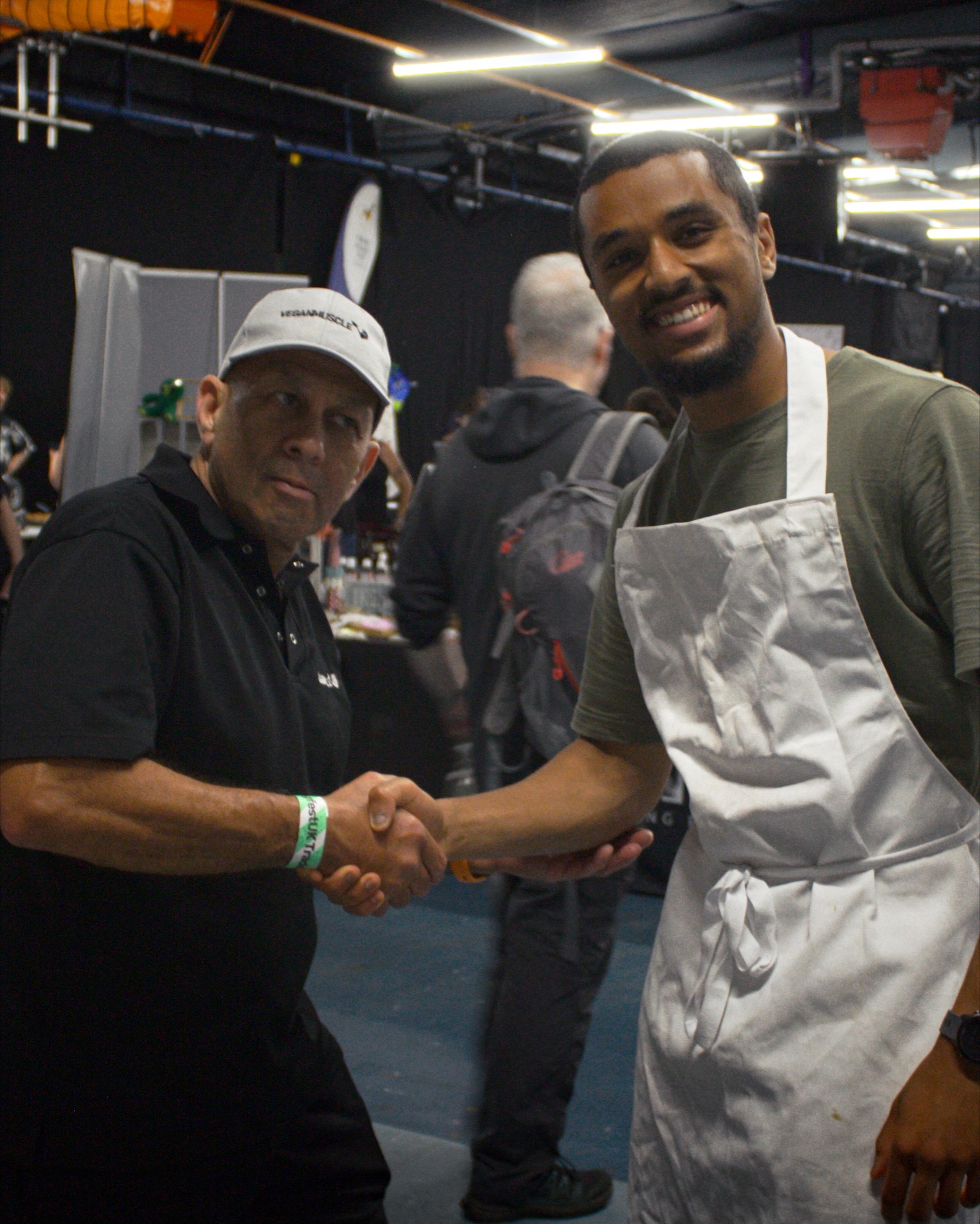 Shaking hands with a guest across the Sanabode table